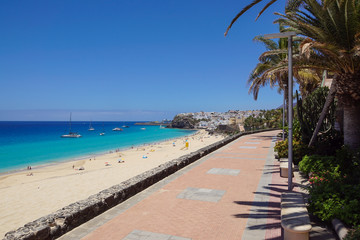 Promenade with tropical plants and flowers along a beach in Morro Jable holiday village, Fuerteventura, Canary Islands, Spain