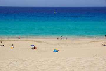 Fototapeta na wymiar Sand dune and coastal promenade along a beach in Morro Jable town, Fuerteventura, Canary Islands, Spain