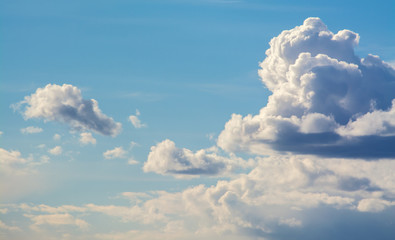 Naklejka na ściany i meble White curly clouds in a blue sky. Sky background