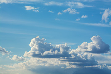 Fototapeta premium White curly clouds in a blue sky. Sky background