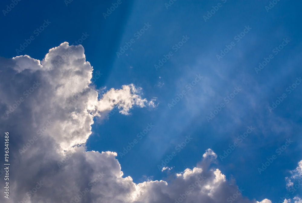 Canvas Prints sun rays against a blue sky in the clouds