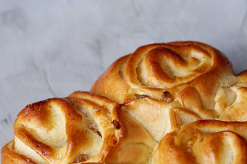 Homemade rose bread on white textured background, close-up, shallow depth of field, top view