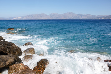 Rocky shore with mountains in the background