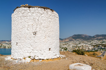 Sunny view of oldfashioned windmills at the hill of Bodrum, Mugla province, Turkey.