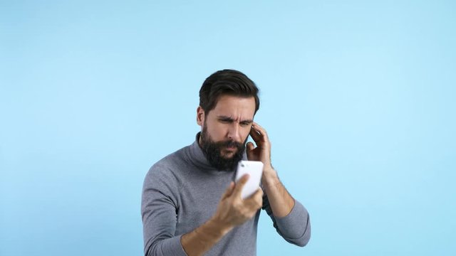 Angry man talking by mobile phone 