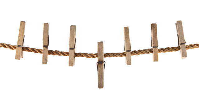 Wooden clothespins on a rope isolated on a white background