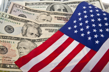 dollars and the US flag as a background