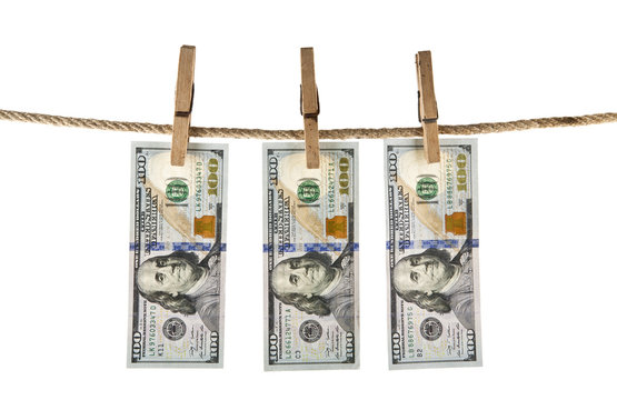 dollars with a clothespin on a rope isolated on a white background