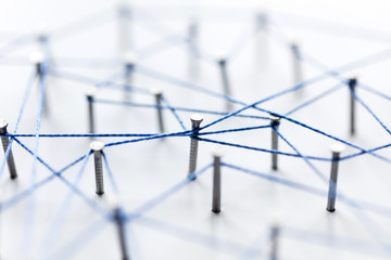 A large grid of pins connected with string. Communication, technology, network concept