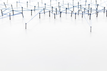 A large grid of pins connected with string. Communication, technology, network concept