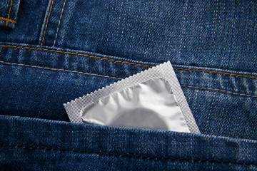 condom in a pocket of blue jeans
