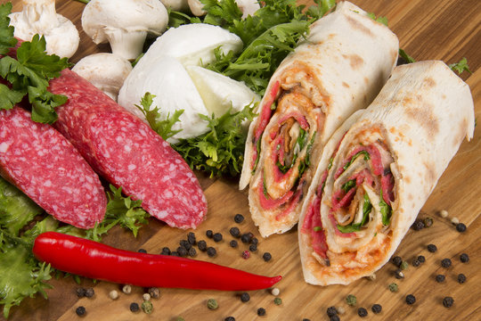 Wrap sandwich with salami, mushrooms  and mozzarella 