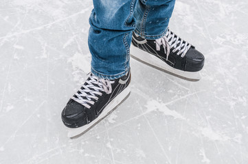 Man`s feet in skating rink