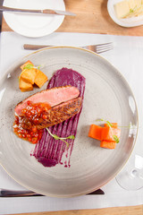 Roast duck breast, red cabbage with apple, roasted potatoes,mountain ash and honey sauce