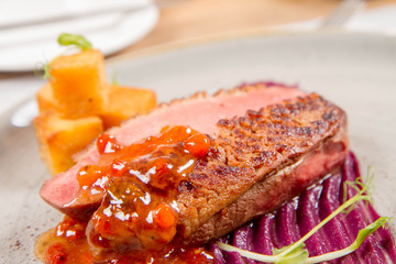 Roast duck breast, red cabbage with apple, roasted potatoes,mountain ash and honey sauce