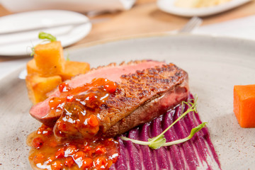 Roast duck breast, red cabbage with apple, roasted potatoes,mountain ash and honey sauce