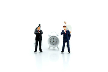 Miniature people : Businessman stand with Clock,Business and time concept.