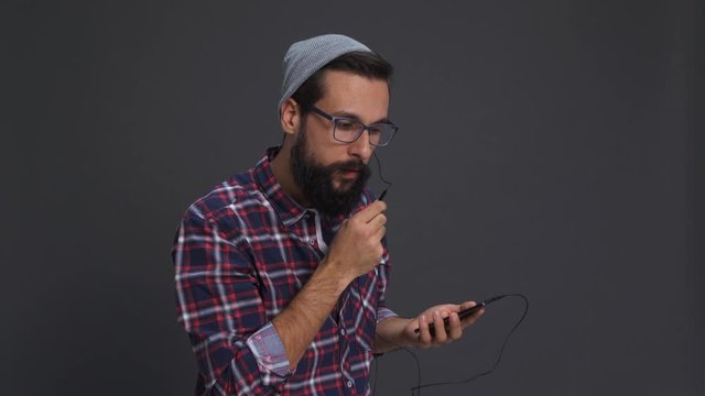 Furious hipster person talking by mobile phone 