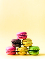 Pyramid of colorful, bright, traditional French Sweet macaroons on retro-vintage background