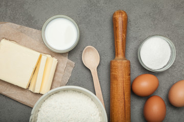 Fototapeta na wymiar Baking ingredients: egg and flour on grey background, dough preparation.