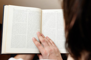 young man holding book and reading