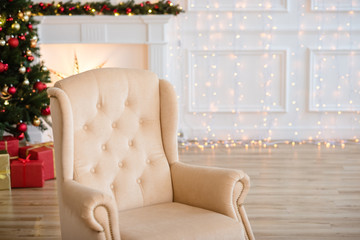 Christmas Tree and Christmas gift boxes in the interior with a fireplace.