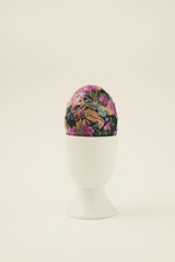 homemade decorated easter egg in an egg-cup