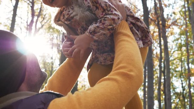 Father playing with child in the forest