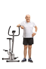 Fototapeta na wymiar Mature man leaning on an exercise bike