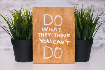Wooden board with motivational text do what they think you can't do