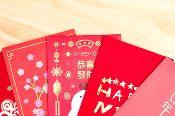 Red envelopes for Chinese New Year on wood background