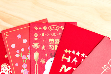 Fototapeta premium Red envelopes for Chinese New Year on wood background