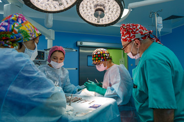 Surgeons operating a patient in operating room