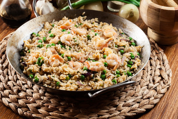 Fried rice with shrimp and vegetables on a frying pan