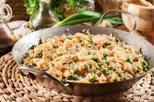 Fried rice with shrimp and vegetables on a frying pan