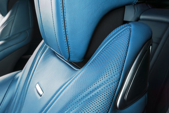 Modern Luxury car inside. Interior of prestige modern car. Comfortable leather red seats. Blue perforated leather. Modern car interior details