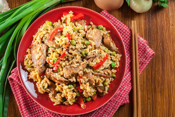 Obraz na płótnie Canvas Fried rice with chicken and vegetables served on a plate