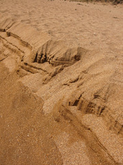 Sandy beach, sea sand running due to the strong wind. Natural textured background
