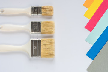 Color palette and brush on a white background. View from above.