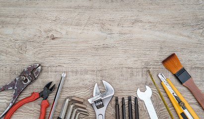 Craftsman tools on grunge wooden background. Assorted work tools set.