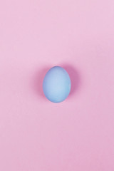 Blue egg on pink background. Top view