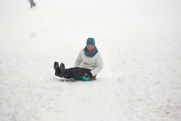 Fototapeta na wymiar Belarus, Grodno, Lake Molochnoe in the winter. People sledding on the slides.
