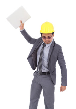 very angry engineer is throwing away his laptop isolated on white background