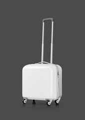 White plastic suitcase or luggage isolated on gray background
