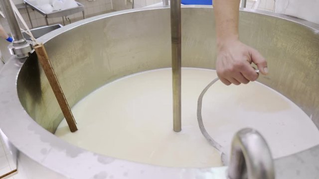 Diary Cheese factory - Filtering milk in the cauldron