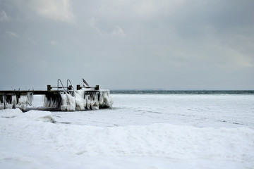 Frozen pier on the sea. Denmark. Baltic Sea. Natural phenomena.