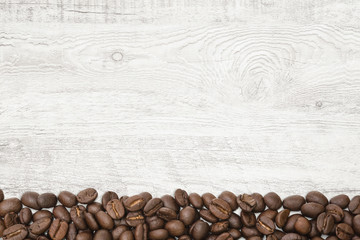 Close-up coffee beans on wood background.