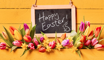 Happy Easter holiday greeting with spring flowers