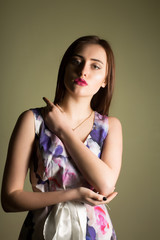 Glorious young woman wearing trendy dress, posing in the shadows