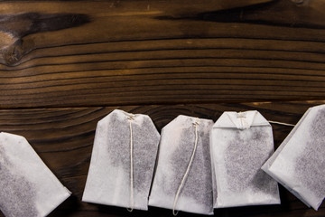Tea bags on wooden table. Top view